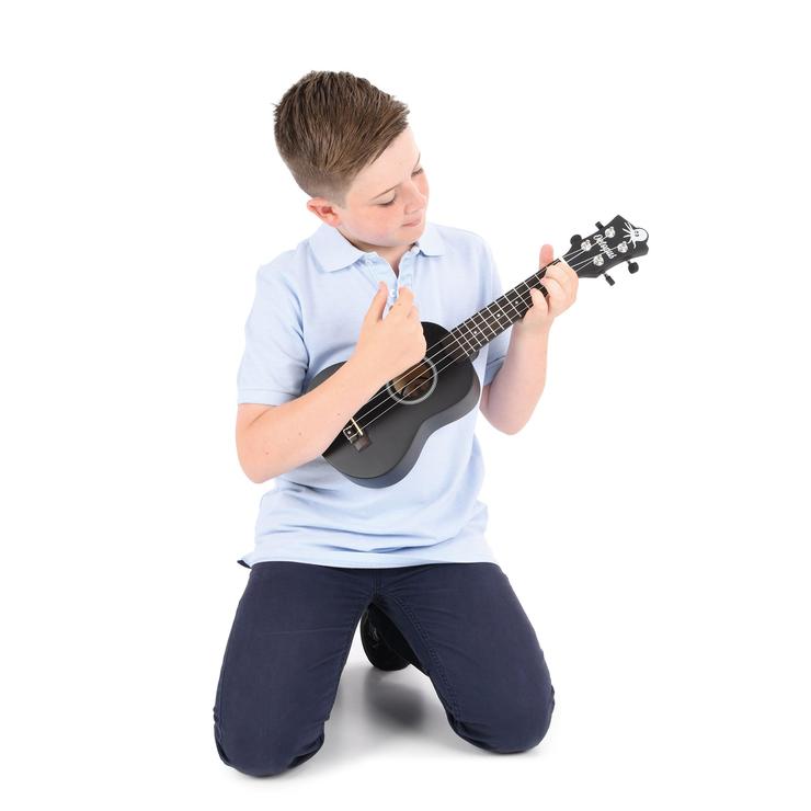 Kid playing with Octopus Natural Series Soprano Ukulele Matt Brown Natural